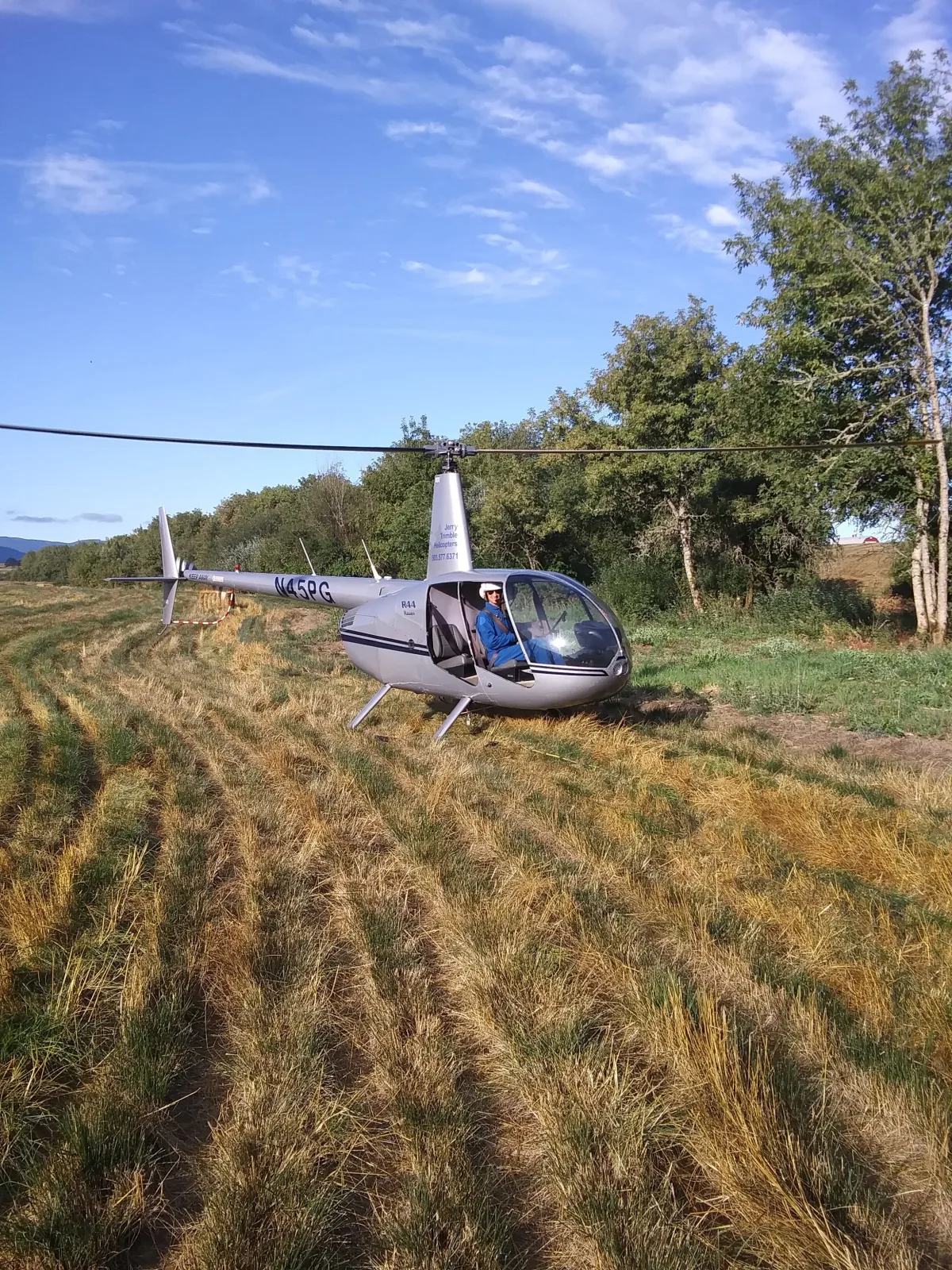 Instructor Bruce alongside a helicopter on the ramp